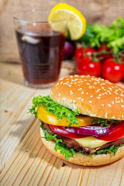 Hamburger and drink with slice of lemon — Stock Photo, Image