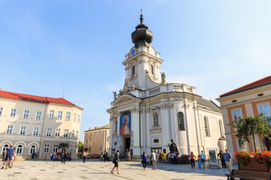Wadowice, Poland - September 07, 2014: Tourists visit the city center of Wadowice. Wadowice is the place of birth of Pope John Paul II clipart