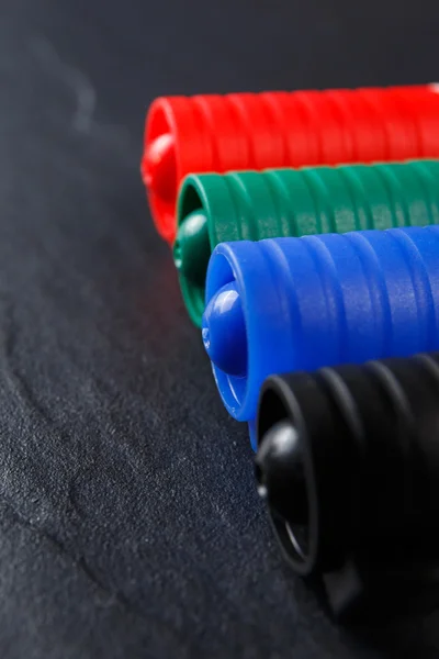 Set of four markers on black background — Stock Photo, Image