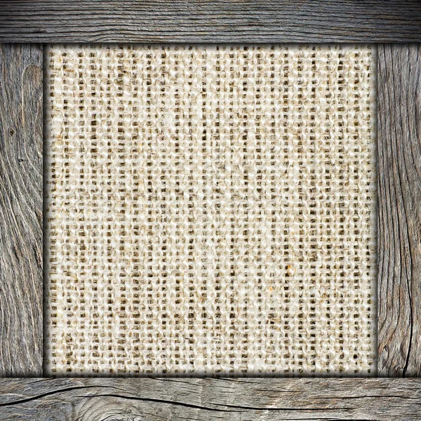 Achtergrond van verfrommeld jute met houten frame — Stockfoto