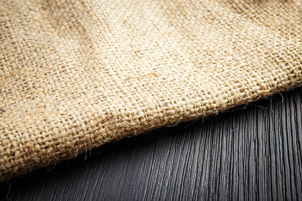 Burlap texture on wooden table background — Stock Photo, Image