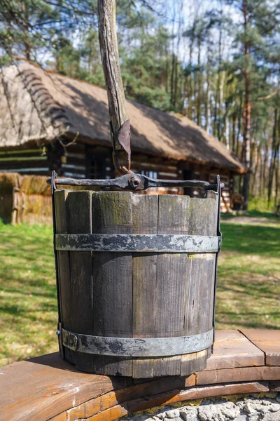 Old wood bucket, water well — Stock fotografie