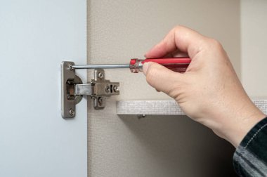 Elinde tornavidayı tutan ve tamir yapan bir adamın yakın çekimi..