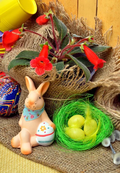 Easter decoration and pussy willow in sackcloth on rustic wooden — Stock Photo, Image