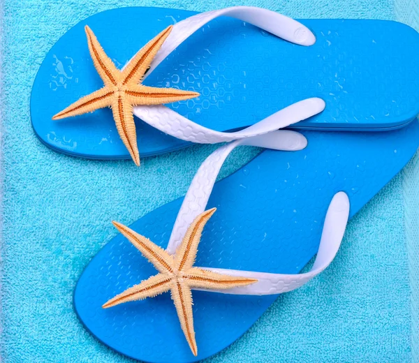 Flip flops med sjöstjärnor och vatten droppar. — Stockfoto