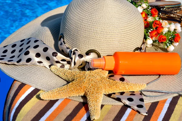 Woman beach hat, bright towel, headphones. — Stock Photo, Image
