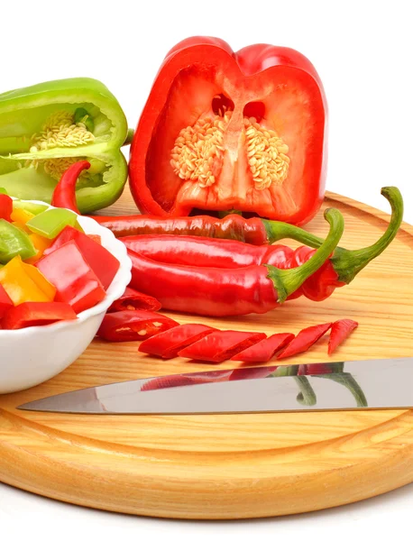 Sweet pepper, chili pepper on the board with a knife — Stock Photo, Image