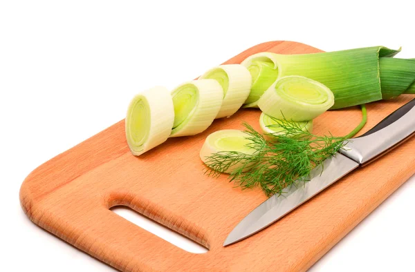 Fresh sliced leek and dill on a wooden board — Stock Photo, Image