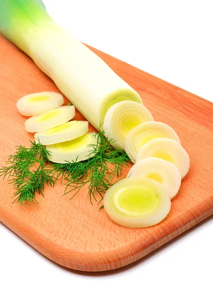 Fresh sliced leek and dill on a wooden board — Stock Photo, Image