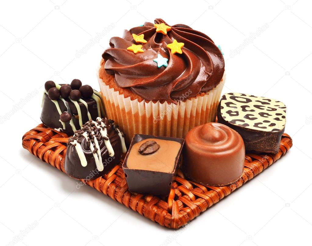 Chocolate muffin with chocolate sweets, candies isolated