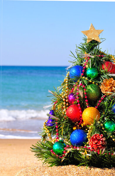 Christmas tree on the sand on the beach