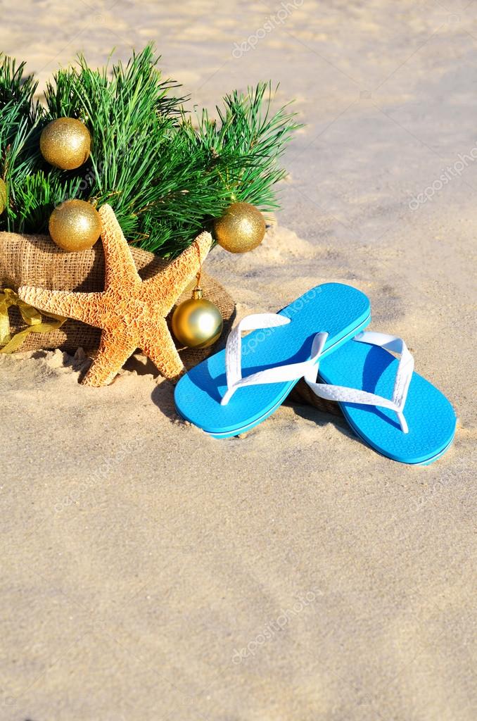 Christmas tree christmas balls, slippers and starfish on th Photo by ©Nika111 59021347