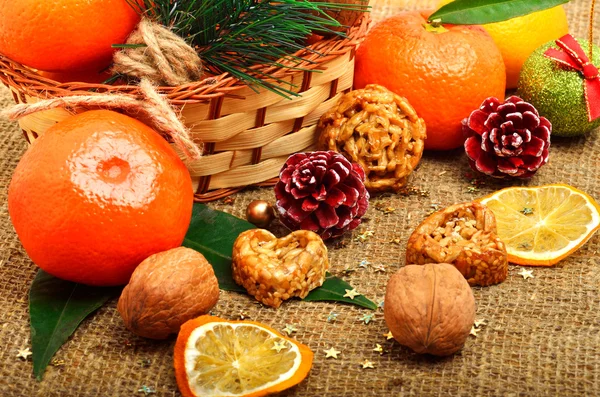 Christmas tangerines with dried lemon, walnuts, pinecone and bri — Stock Photo, Image