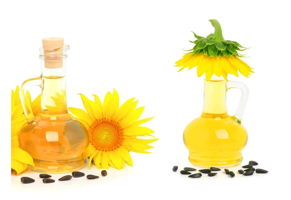 Carafe with vegetable oil and sunflowers — Stock Photo, Image