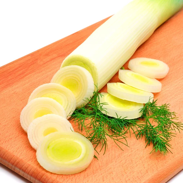 Fresh sliced leek and dill on a wooden board — Stock Photo, Image