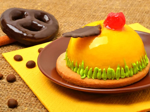 Delicioso pastel amarillo con cereza en plato con galletas de chocolate — Foto de Stock