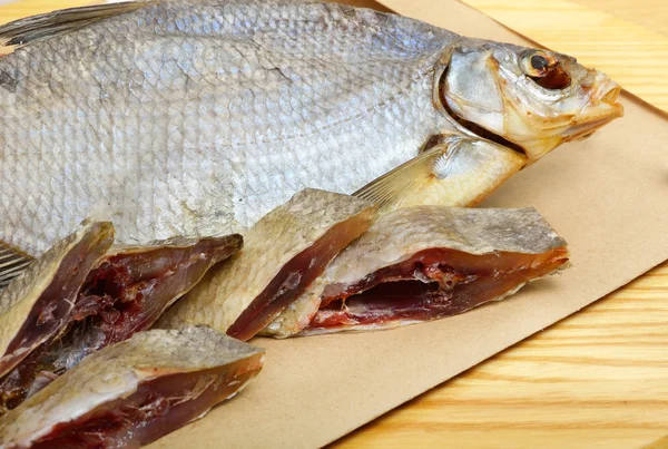 Bream on paper, on the wooden background — Stock Photo, Image