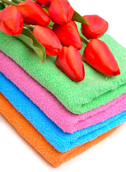 Stack of towels and red tulips — Stock Photo, Image