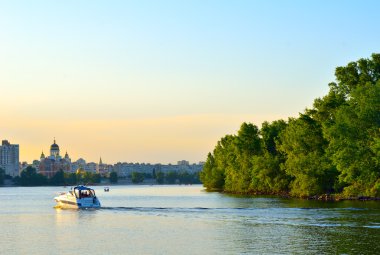 Gün batımında Dinyeper Nehri üzerinde tekne yüzen