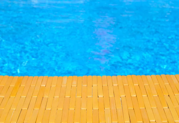 Swimming pool and wooden deck for backgrounds — Stock Photo, Image