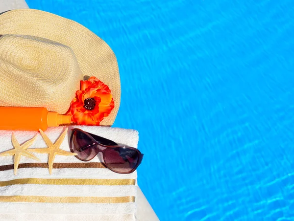 Cappello da spiaggia, occhiali da sole, telo da bagno, spray solare, stelle marine vicino — Foto Stock