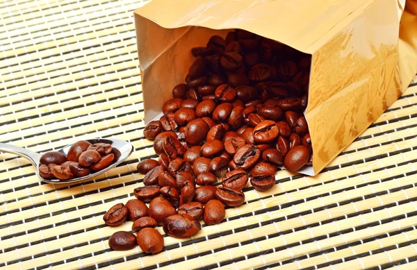 Coffee beans on the package on tablecloth — Stock Photo, Image