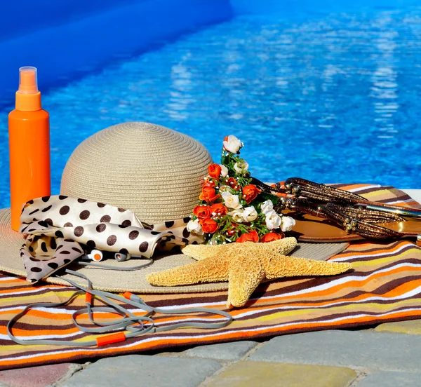 Beach hat, flip flops, head phones, sun spray. — Stock Photo, Image