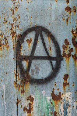 Evin duvarında anarşi sembolü var. Solcu ve anarşist protestoların sembolü. Grunge arkaplanındaki anarşi sembolü, dikey resim