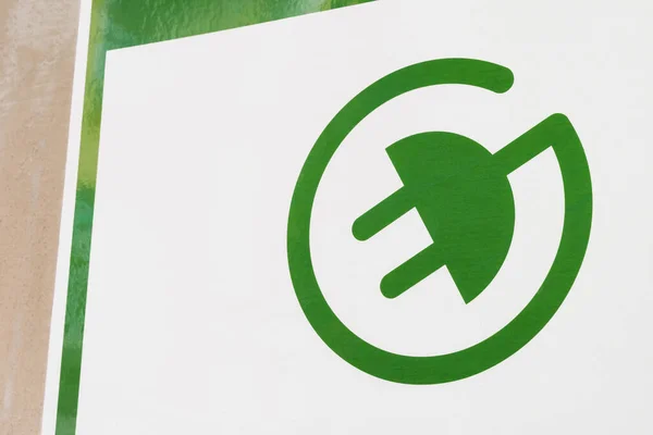 green Electric Vehicle Recharge Point Sign. A green sign of a power supply for electric car