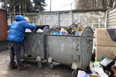 Çöplükte yemek ararken işini kaybeden yalnız bir adam. evsizlerin ve işsizlerin sorunu