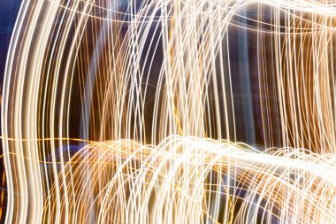 Abstract pattern of the golden city lights from cars, streetlights and bars. Abstract blurred background. Colorful pattern for creative background