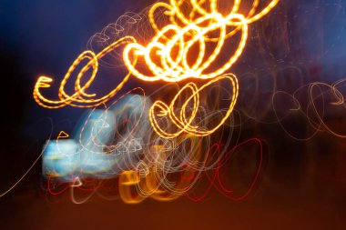 gold and red Neon circles at long exposure shot. Street color lights abstract painting. Abstract city lights at motion exposure time with slow shutter speed effect