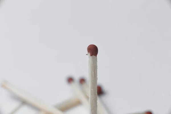 A scattering of matches on a white background close-up