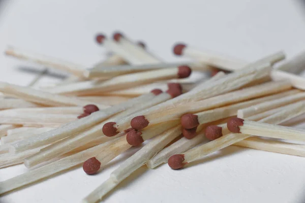 A scattering of matches on a white background close-up