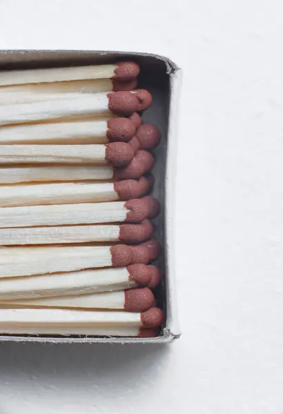 A scattering of matches on a white background close-up