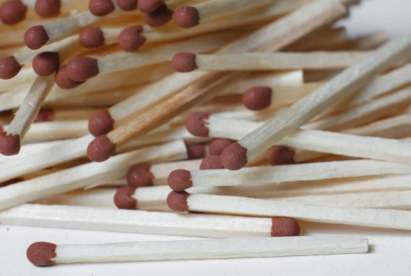 A scattering of matches on a white background close-up