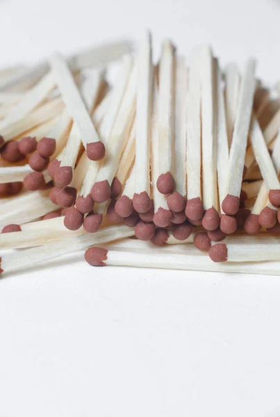 A scattering of matches on a white background close-up