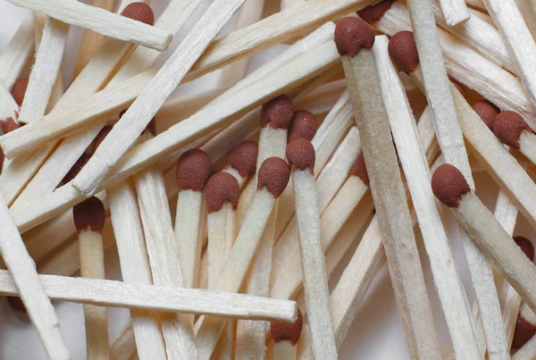 A scattering of matches on a white background close-up