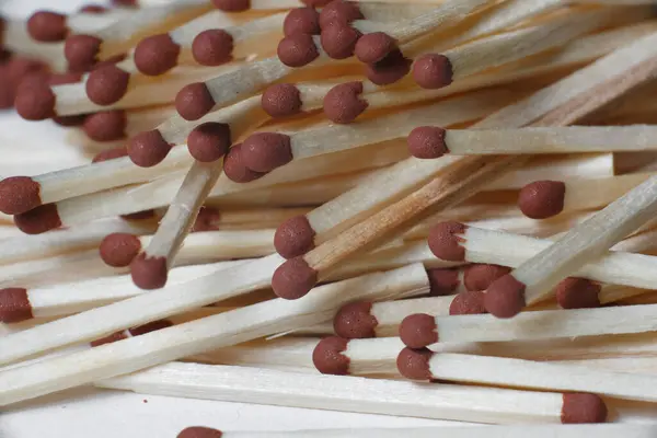 A scattering of matches on a white background close-up