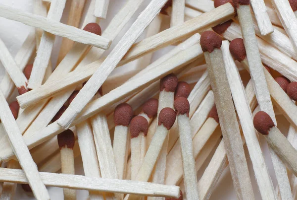 A scattering of matches on a white background close-up