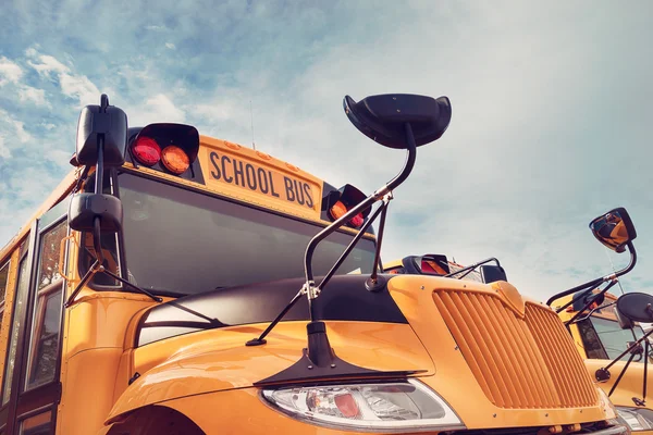 Yellow school bus against autumn sky — Stock Photo, Image