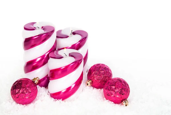 Holiday candles and Christmas ornaments on snow — Stock Photo, Image