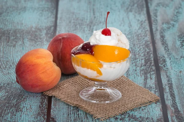 Vanilla peach melba ice cream with peach fruits Stock Picture