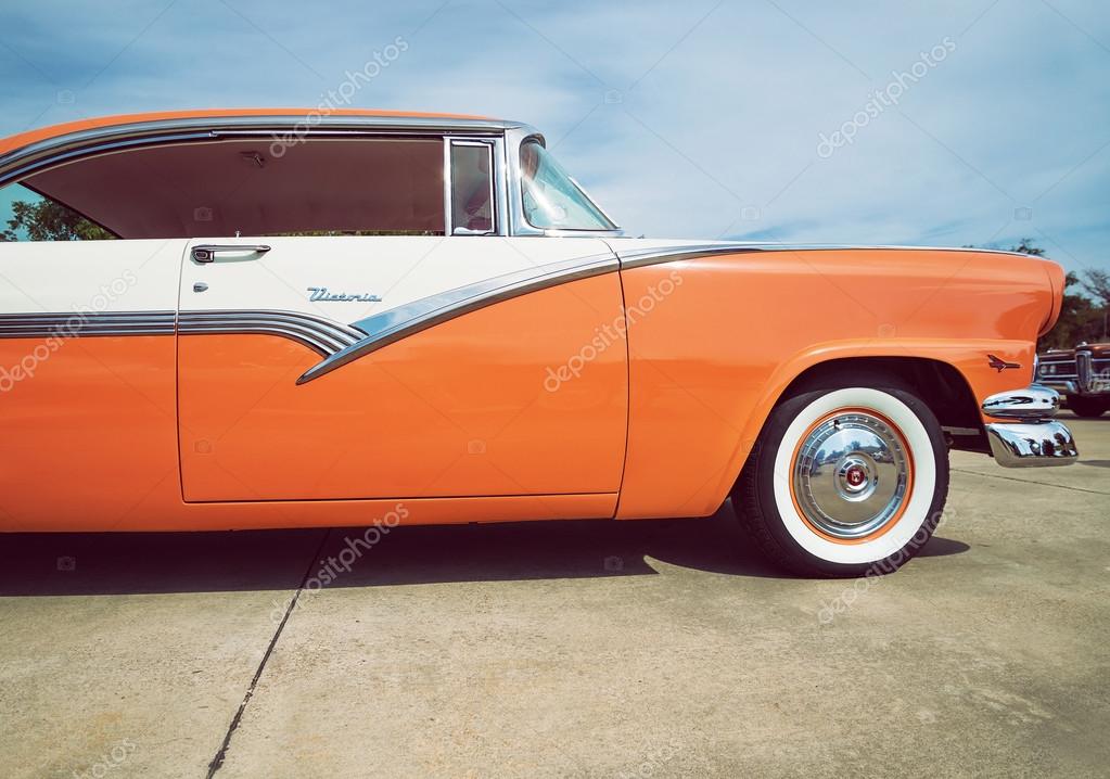 Mandarin orange and white 1956 Ford Victoria classic car Stock
