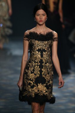 model walks the runway wearing Marchesa Fall 2016