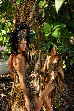 İki model tropikal ağacın önünde poz 