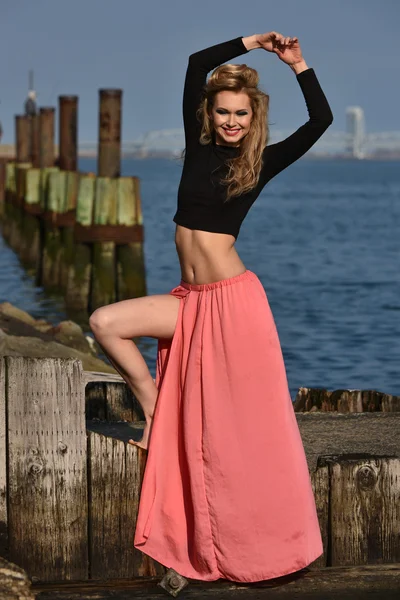 Model posing at old ocean pier location — Stock Photo, Image