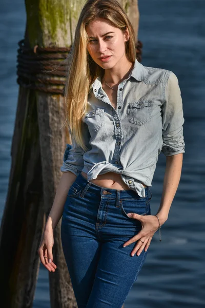 Girl wearing denim shirt and jeans — Stock Photo, Image