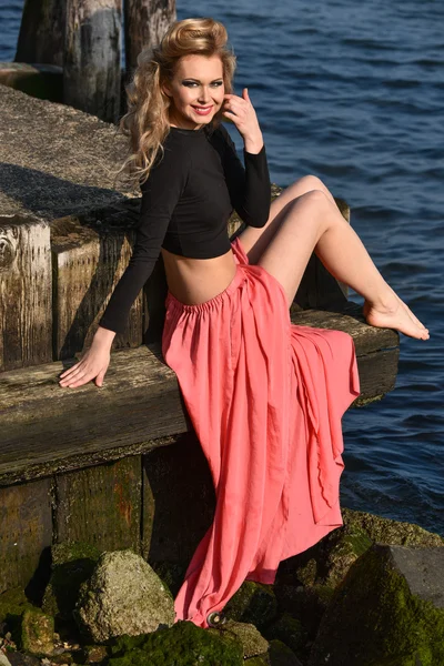Model posing at old ocean pier location — Stock Photo, Image