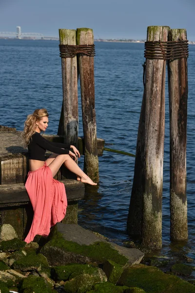 Model posing at old ocean pier location — Stock Photo, Image